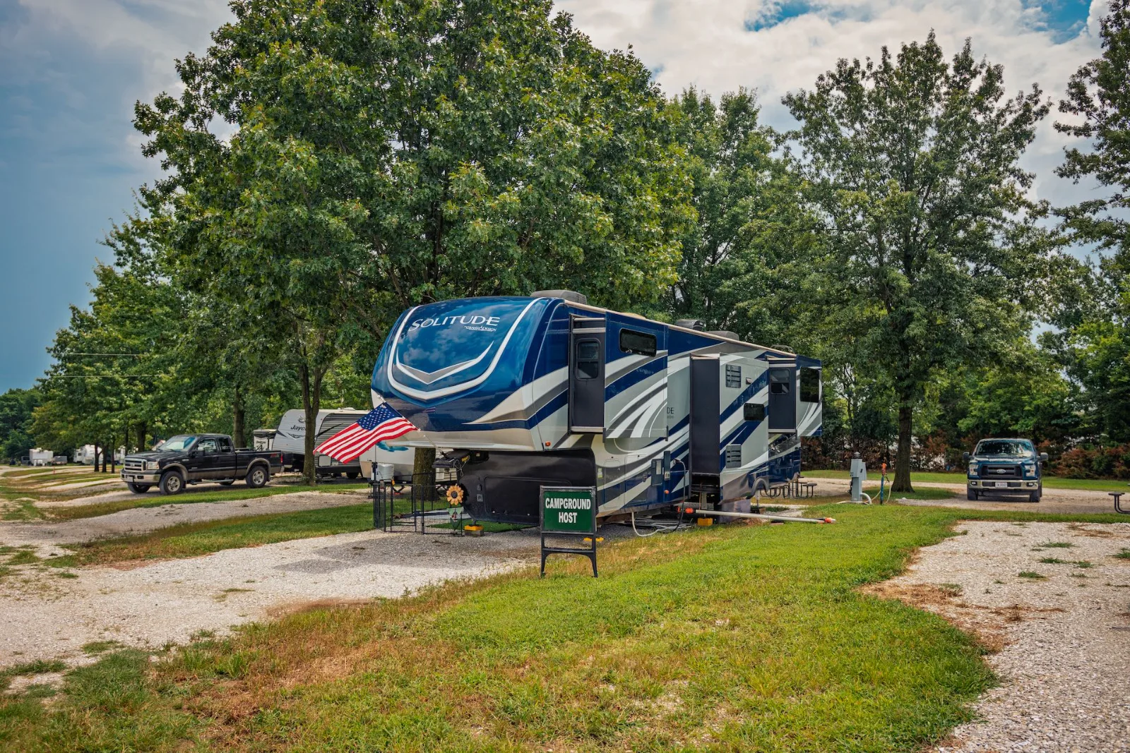 The campground host site at Katy Stop RV Park, marked with a Campground Host sign and flag