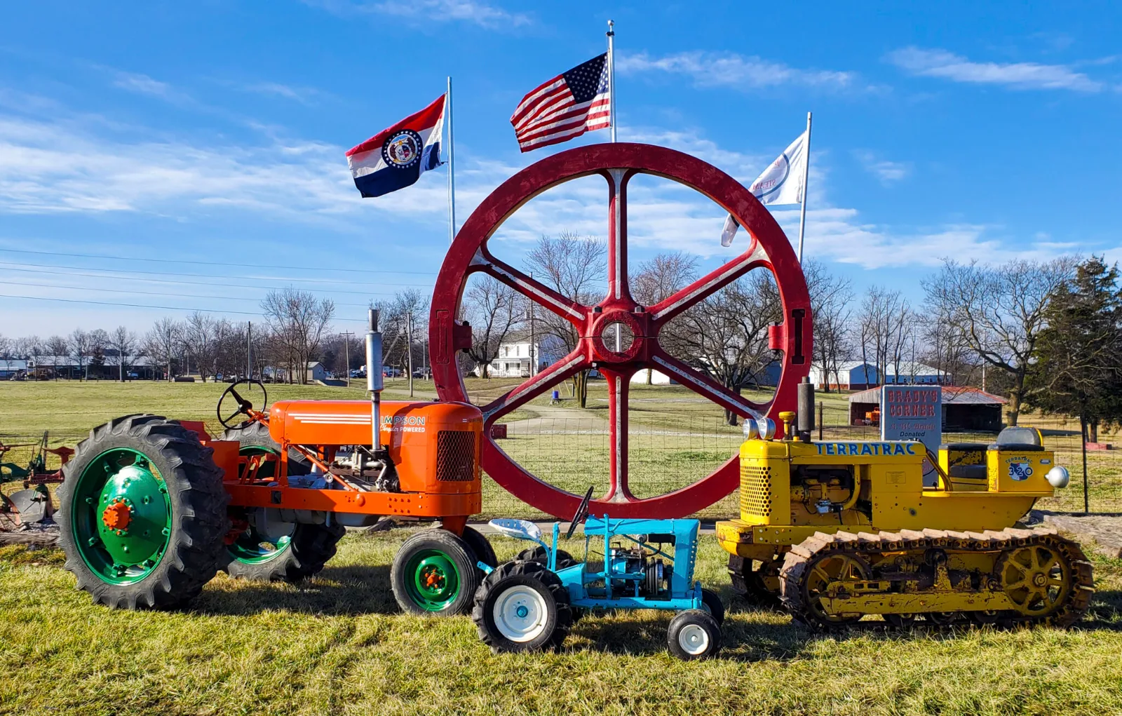 Antique tractors and a giant red flywheel on display at the Back to the Farm Reunion showgrounds in Boonville